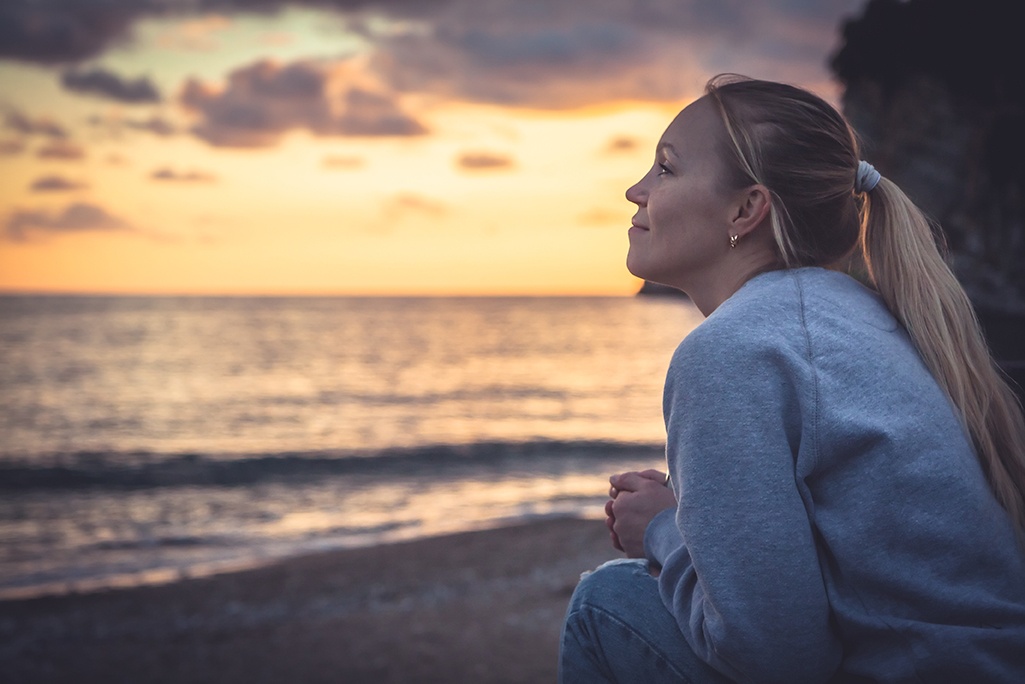 Pensive lonely smiling woman looking with hope into horizon duri Breaking up