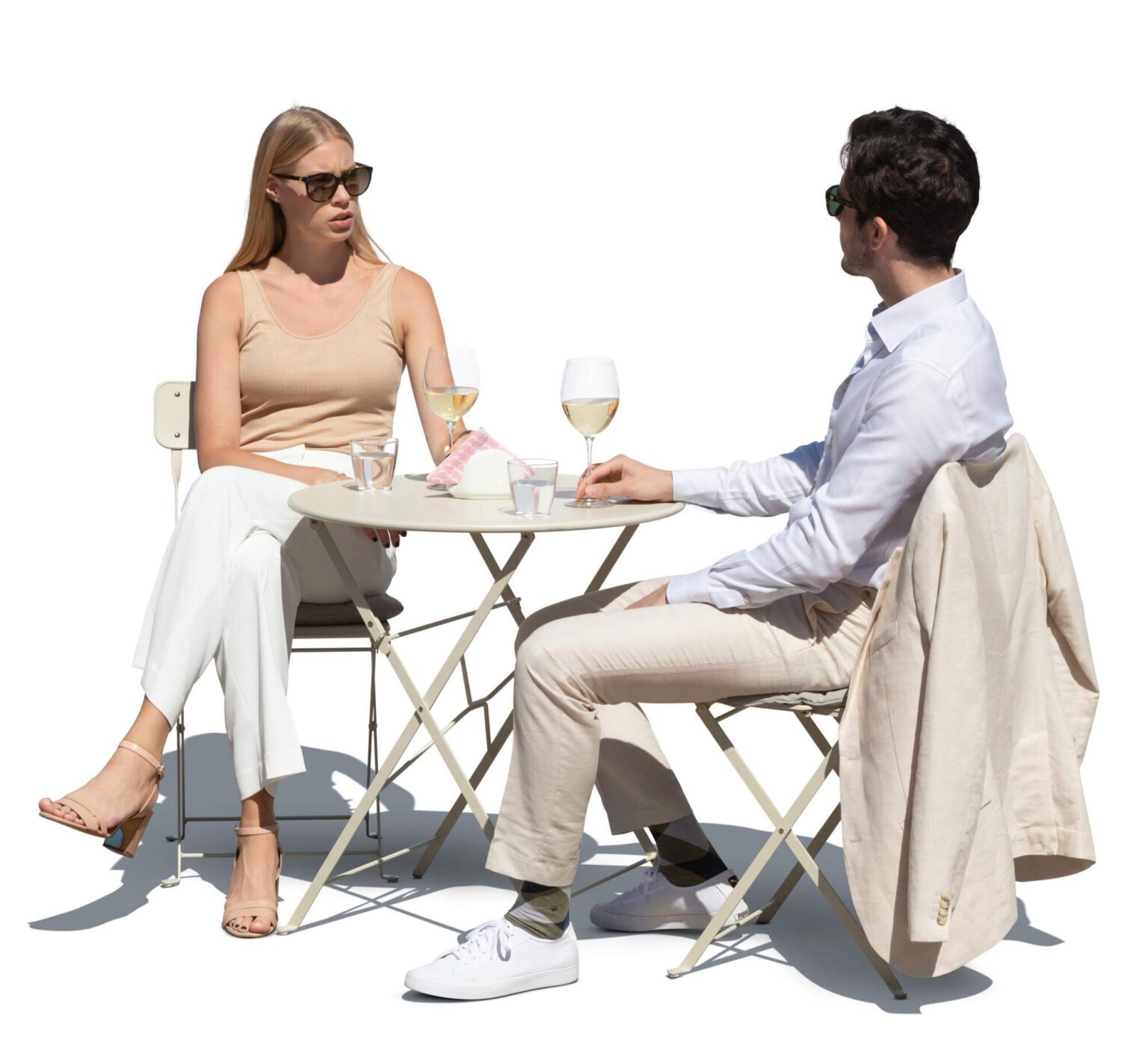 Couple Having Wine Together Two people sitting at a small table having wine and conversation outdoors